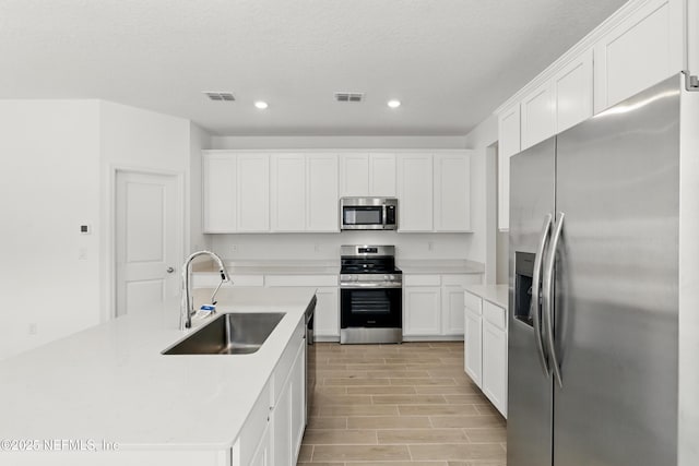 9053 Whinny Way, Jacksonville, FL 32219 - kitchen with stainless steel appliances, a sink, recessed lighting, white cabinets, and light countertops