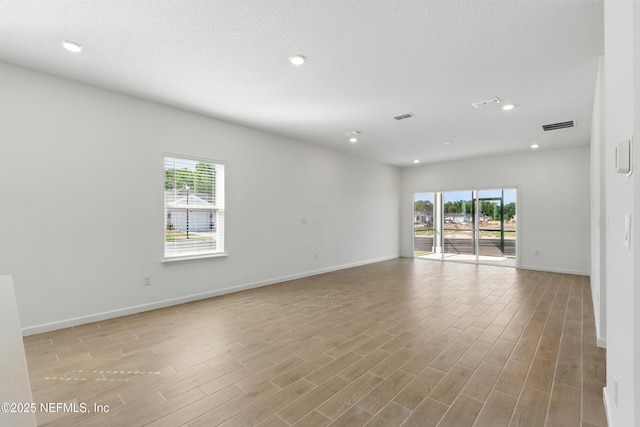 9053 Whinny Way, Jacksonville, FL 32219 - empty room with plenty of natural light, baseboards, light wood-style floors, and recessed lighting