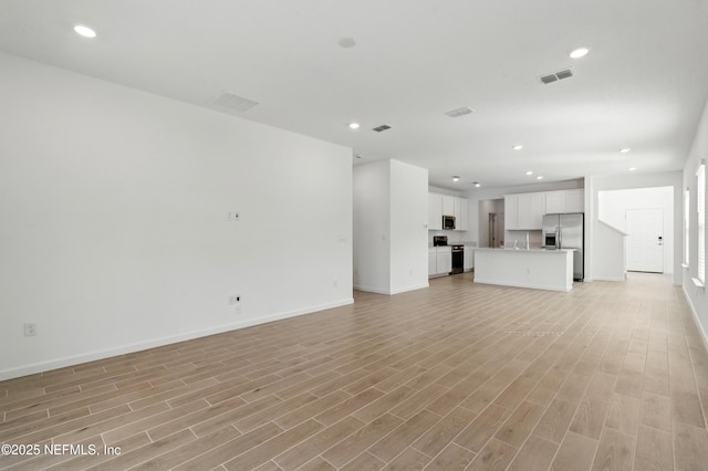 9053 Whinny Way, Jacksonville, FL 32219 - unfurnished living room with baseboards, recessed lighting, and light wood-style floors