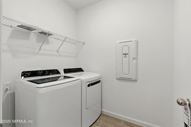 9053 Whinny Way, Jacksonville, FL 32219 - laundry room featuring washing machine and dryer, electric panel, baseboards, and wood tiled floors