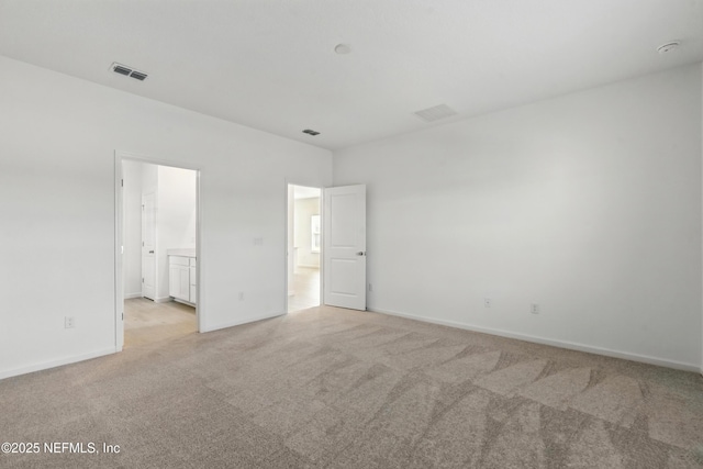 9053 Whinny Way, Jacksonville, FL 32219 - unfurnished bedroom with light colored carpet, baseboards, and connected bathroom