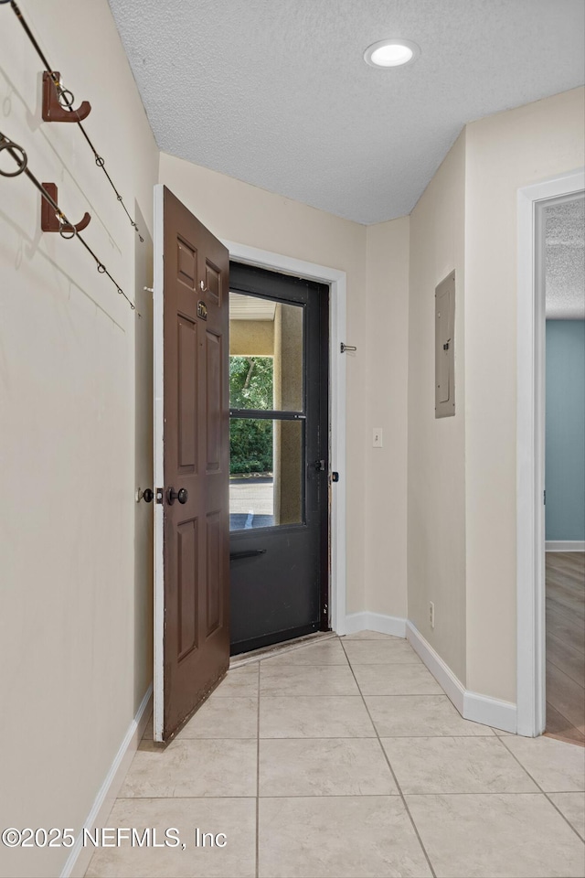 1255 Ponce Island Dr Unit F-779, Saint Augustine, FL 32084 - entryway with baseboards, a textured ceiling, light tile patterned floors, electric panel, and recessed lighting