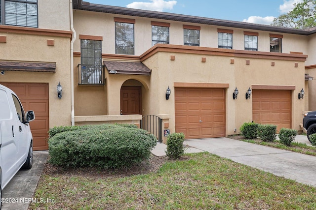 5346 Brighton Park Ln, Jacksonville, FL 32210 - view of property featuring stucco siding, concrete driveway, and an attached garage