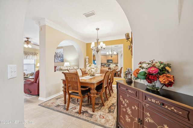 5346 Brighton Park Ln, Jacksonville, FL 32210 - dining space with arched walkways, a chandelier, crown molding, light tile patterned floors, and a ceiling fan