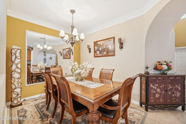 5346 Brighton Park Ln, Jacksonville, FL 32210 - dining room with arched walkways, ornamental molding, a chandelier, light tile patterned floors, and baseboards