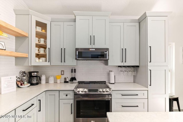 66 Oneida St, Saint Augustine, FL 32084 - kitchen featuring electric stove, light countertops, and tasteful backsplash