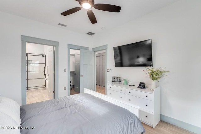 66 Oneida St, Saint Augustine, FL 32084 - bedroom with a walk in closet, light wood-style flooring, ensuite bath, a ceiling fan, and baseboards