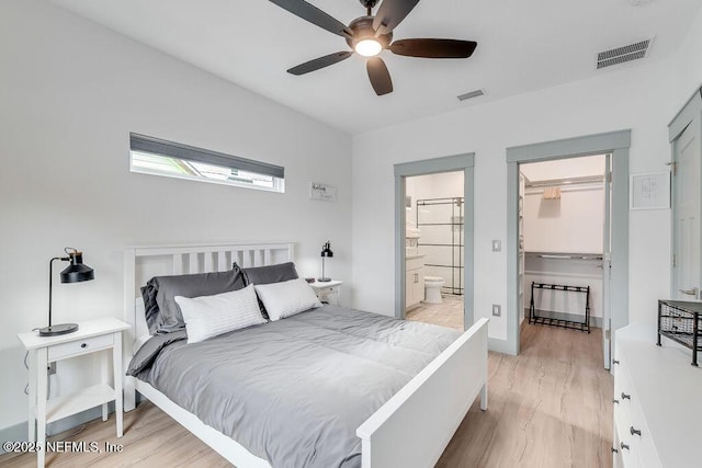 66 Oneida St, Saint Augustine, FL 32084 - bedroom featuring a spacious closet, light wood-type flooring, ceiling fan, ensuite bathroom, and baseboards