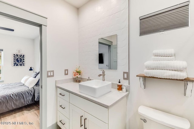 66 Oneida St, Saint Augustine, FL 32084 - bathroom with vanity, toilet, ensuite bathroom, and wood finished floors