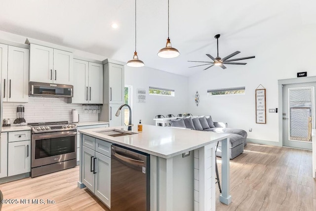 66 Oneida St, Saint Augustine, FL 32084 - kitchen with appliances with stainless steel finishes, gray cabinets, open floor plan, light countertops, and a sink