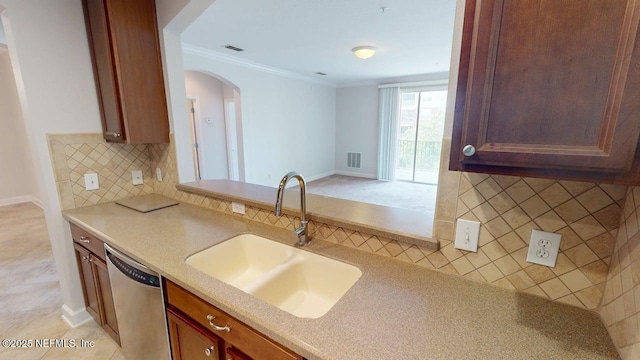 4480 Deerwood Lake Pkwy Unit 633, Jacksonville, FL 32216 - kitchen featuring a sink, dishwasher, arched walkways, ornamental molding, and tasteful backsplash