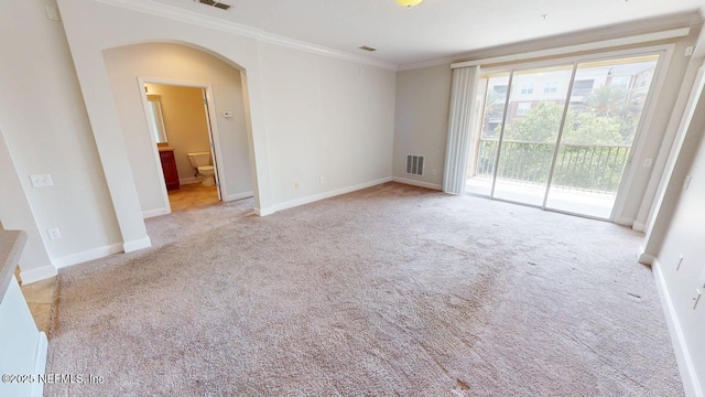 4480 Deerwood Lake Pkwy Unit 633, Jacksonville, FL 32216 - spare room featuring arched walkways, carpet floors, crown molding, and baseboards