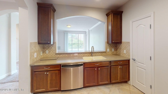4480 Deerwood Lake Pkwy Unit 633, Jacksonville, FL 32216 - kitchen with dishwasher, a sink, arched walkways, light countertops, and decorative backsplash