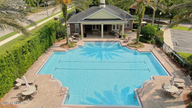 4480 Deerwood Lake Pkwy Unit 633, Jacksonville, FL 32216 - community pool with a patio area and an outbuilding