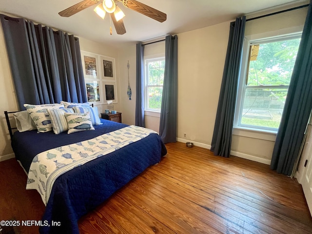 5000 Elm St, Welaka, FL 32189 - bedroom featuring hardwood / wood-style floors, baseboards, and a ceiling fan