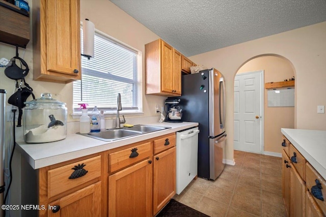 12 Roxland Ln, Palm Coast, FL 32164 - kitchen with a sink, dishwasher, light countertops, a textured ceiling, and light tile patterned flooring