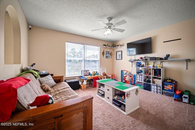 12 Roxland Ln, Palm Coast, FL 32164 - playroom with carpet floors, a ceiling fan, a textured ceiling, and arched walkways