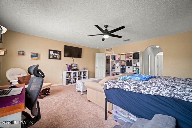 12 Roxland Ln, Palm Coast, FL 32164 - carpeted bedroom featuring arched walkways, a textured ceiling, and ceiling fan
