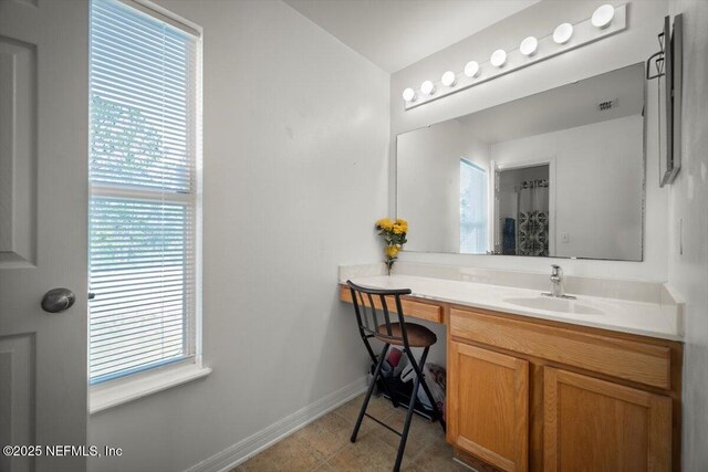 12 Roxland Ln, Palm Coast, FL 32164 - bathroom featuring baseboards, healthy amount of natural light, and vanity