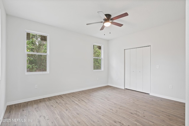 11807 Lem Turner Rd, Jacksonville, FL 32218 - unfurnished bedroom featuring wood finished floors, baseboards, a closet, and ceiling fan