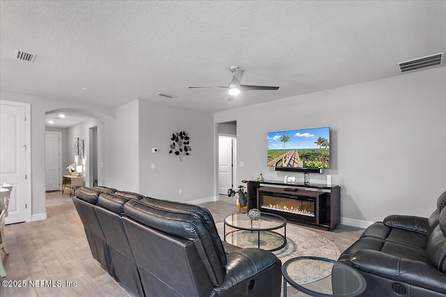 52 Bent Lake Ct, Saint Augustine, FL 32095 - living area with arched walkways, a ceiling fan, baseboards, and a textured ceiling