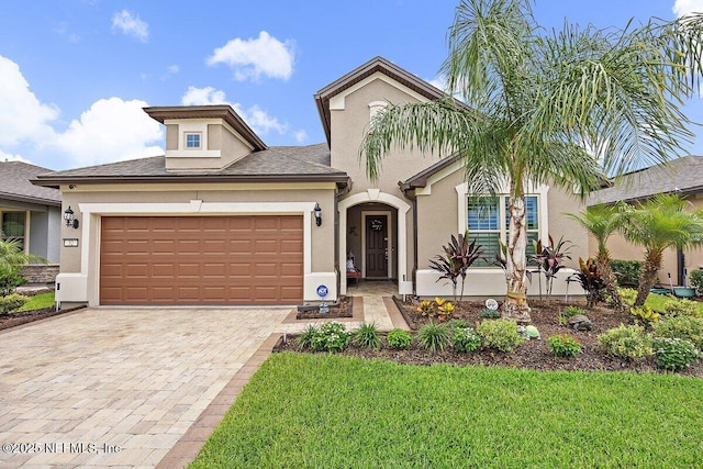 52 Bent Lake Ct, Saint Augustine, FL 32095 - view of front of home with stucco siding, an attached garage, driveway, and a front yard