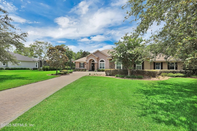 104 Hickory Hill Dr, Saint Augustine, FL 32095 - view of front of property featuring a front lawn, stucco siding, and driveway