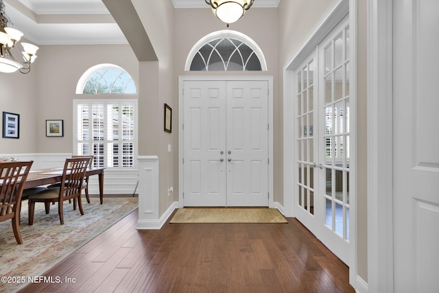 104 Hickory Hill Dr, Saint Augustine, FL 32095 - entryway featuring dark wood-type flooring, a chandelier, and ornamental molding