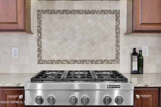 104 Hickory Hill Dr, Saint Augustine, FL 32095 - kitchen view of stainless steel gas stovetop, backsplash, and light stone countertops