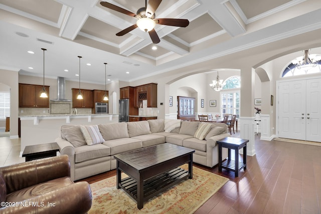 104 Hickory Hill Dr, Saint Augustine, FL 32095 - living room featuring a chandelier, arched walkways, coffered ceiling, beam ceiling, and crown molding