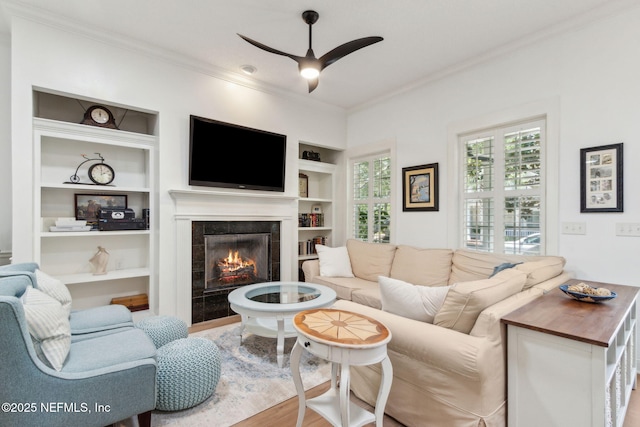 1743 Azalea St, Fernandina Beach, FL 32034 - living area with crown molding, built in features, a fireplace, ceiling fan, and healthy amount of natural light