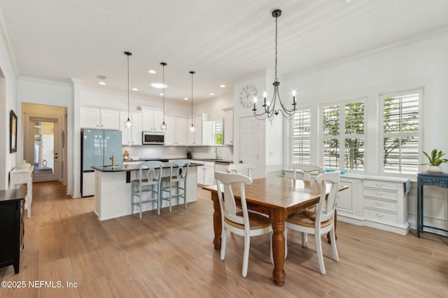 1743 Azalea St, Fernandina Beach, FL 32034 - dining room featuring a chandelier, crown molding, light wood-style flooring, and recessed lighting