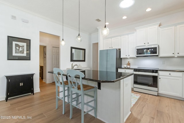1743 Azalea St, Fernandina Beach, FL 32034 - kitchen with white microwave, electric range oven, freestanding refrigerator, crown molding, and light wood-type flooring
