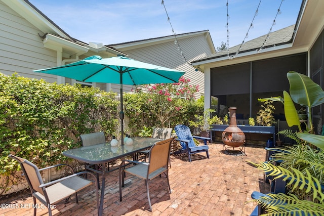 1743 Azalea St, Fernandina Beach, FL 32034 - view of patio featuring outdoor dining area and a sunroom