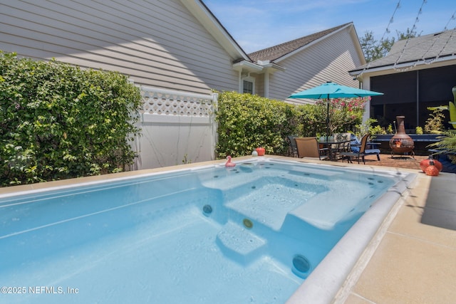 1743 Azalea St, Fernandina Beach, FL 32034 - view of pool featuring a jacuzzi, outdoor dining area, a swimming pool, a sunroom, and a patio area