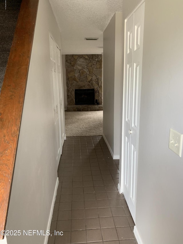 6014 Du-Clay Rd, Jacksonville, FL 32244 - hall with a textured ceiling, tile patterned floors, baseboards, and carpet