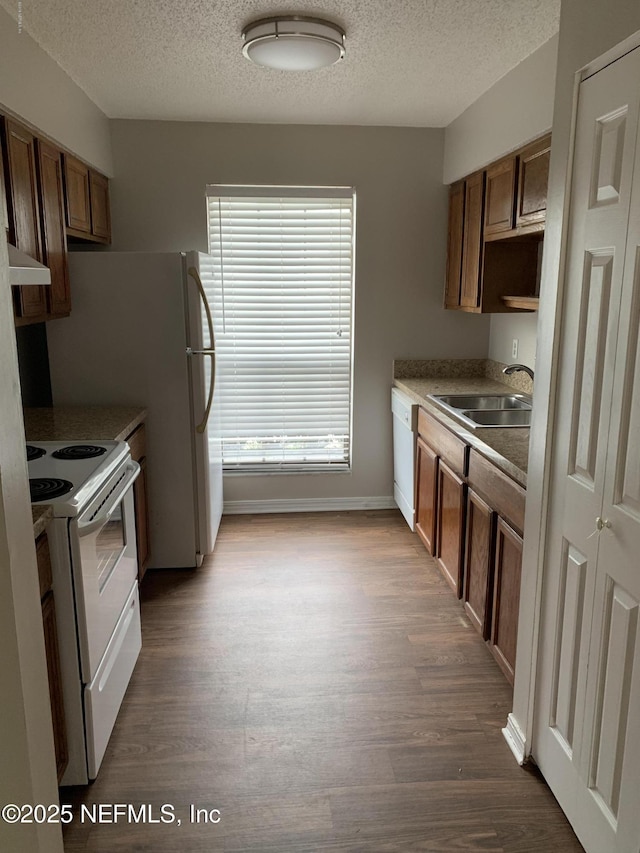 6014 Du-Clay Rd, Jacksonville, FL 32244 - kitchen featuring white appliances, a sink, dark wood finished floors, range hood, and a textured ceiling