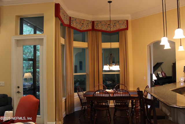 204 Stonewell Dr, Saint Johns, FL 32259 - dining area with a chandelier, crown molding, and arched walkways