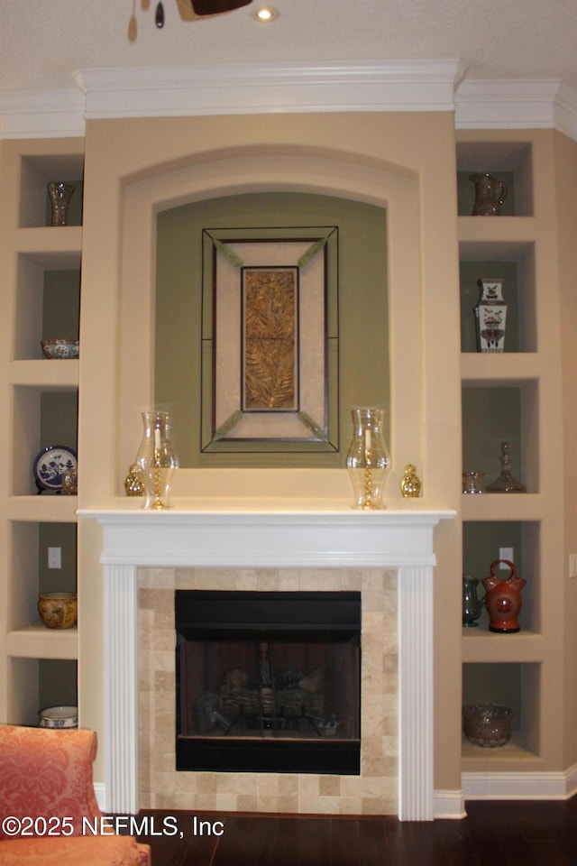 204 Stonewell Dr, Saint Johns, FL 32259 - detailed view of built in shelves, crown molding, a tile fireplace, and wood finished floors