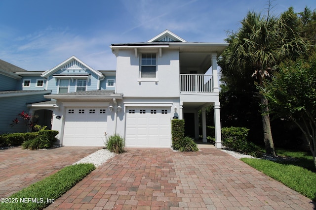 58 Islander Cir, Saint Augustine, FL 32080 - view of front of property featuring decorative driveway, an attached garage, stucco siding, and a balcony