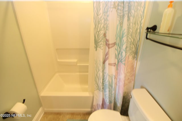 58 Islander Cir, Saint Augustine, FL 32080 - bathroom with toilet, baseboards, and shower / bathtub combination with curtain