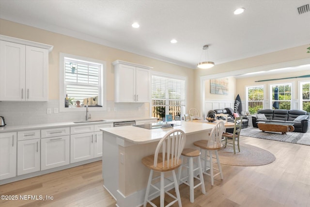 125 5th St, Saint Augustine, FL 32080 - kitchen with a sink, a kitchen island, white cabinetry, open floor plan, and recessed lighting
