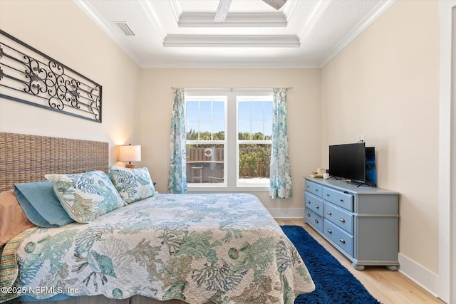 125 5th St, Saint Augustine, FL 32080 - bedroom featuring wood finished floors, crown molding, a raised ceiling, and baseboards