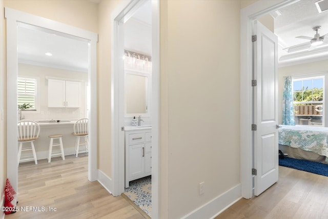 125 5th St, Saint Augustine, FL 32080 - hall featuring light wood-style flooring, plenty of natural light, a sink, baseboards, and recessed lighting