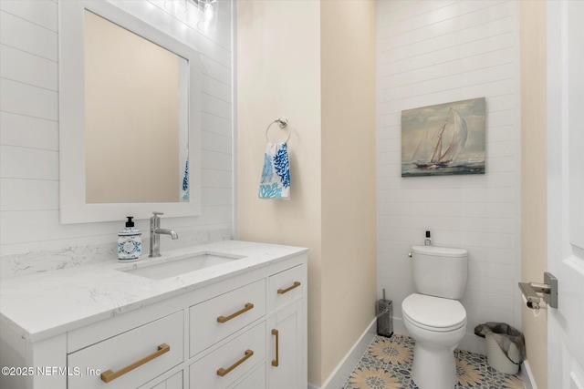 125 5th St, Saint Augustine, FL 32080 - half bathroom with vanity, toilet, tile patterned floors, and baseboards