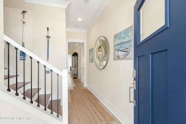 125 5th St, Saint Augustine, FL 32080 - foyer with baseboards, stairway, wood finished floors, recessed lighting, and crown molding