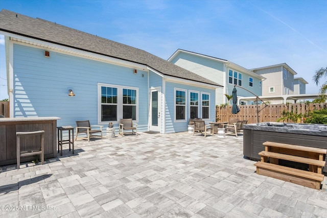 125 5th St, Saint Augustine, FL 32080 - back of house featuring a hot tub, a patio area, and outdoor lounge area