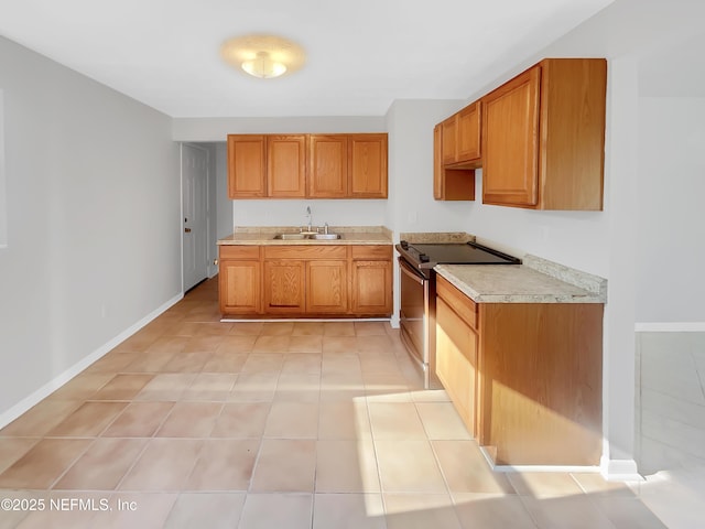 2926 Hunt St, Jacksonville, FL 32254 - kitchen with stainless steel electric stove, a sink, light countertops, baseboards, and brown cabinets
