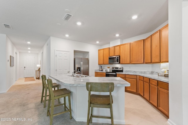 1305 Panther Lk Parkway, Jacksonville, FL 32221 - kitchen with stainless steel appliances, an island with sink, a breakfast bar, light countertops, and a sink