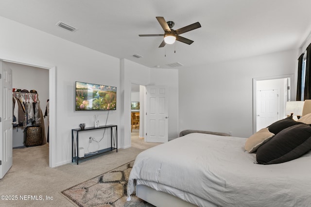 1305 Panther Lk Parkway, Jacksonville, FL 32221 - bedroom featuring a spacious closet, light carpet, a closet, a ceiling fan, and connected bathroom